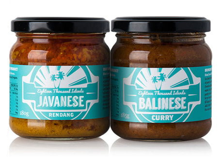Two glass jars of Eighteen Thousand Islands curries, featuring Javanese Rendang and Balinese Curry, with teal labels and black lids on a white background.
